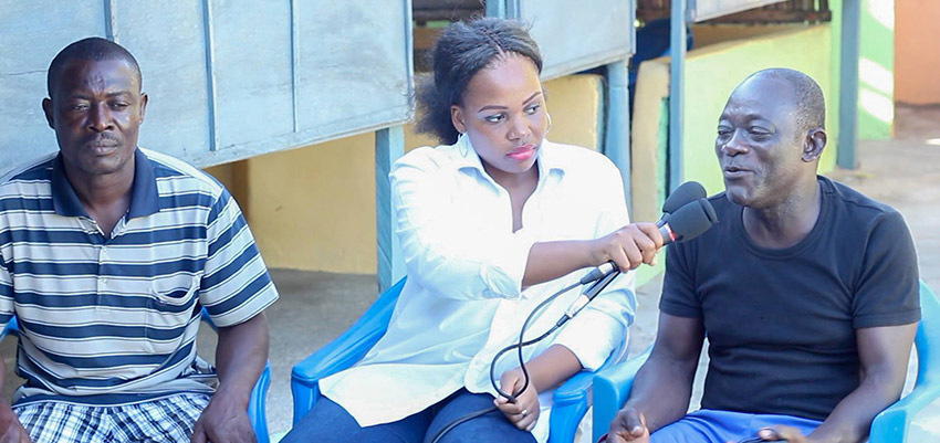 Radio reporter Deborah Amuwo (centre) interviewing two men (sitting on her left and right) who tried the journey to Europe but returned home.