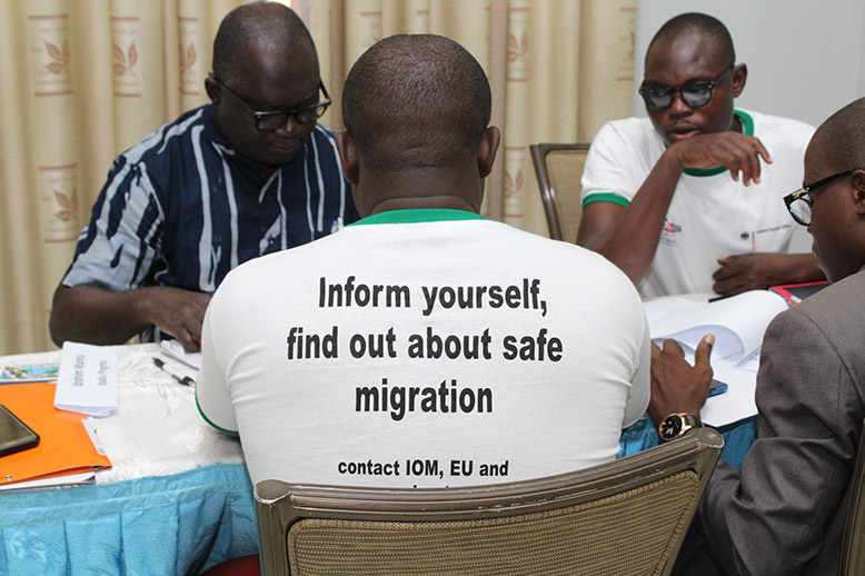 A group of young journalists from Ghana sitting at a conference at a training session for journalists on how to handle topics of irregular migration.